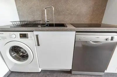 a kitchen with a washing machine and a sink at Le Galion - City centre - Bright - AC - Parking in Cagnes-sur-Mer