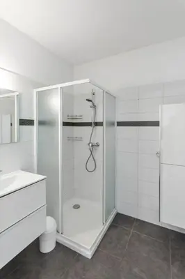 a white bathroom with a shower and a sink at Le Galion - City centre - Bright - AC - Parking in Cagnes-sur-Mer