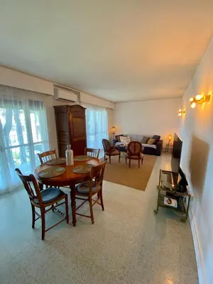 a living room with a table and chairs at Centre ville de St Jean Cap Ferrat in Saint-Jean-Cap-Ferrat