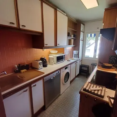 a kitchen with a microwave and a washer and dryer at Centre ville de St Jean Cap Ferrat in Saint-Jean-Cap-Ferrat