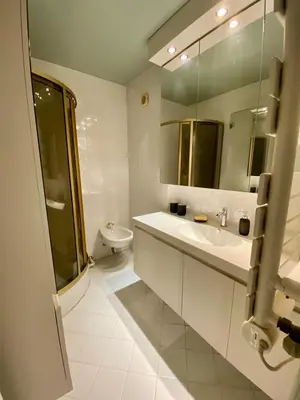 a white bathroom with a sink and a toilet at Centre ville de St Jean Cap Ferrat in Saint-Jean-Cap-Ferrat
