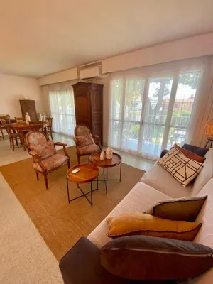 a living room with a couch and chairs and a table at Centre ville de St Jean Cap Ferrat in Saint-Jean-Cap-Ferrat