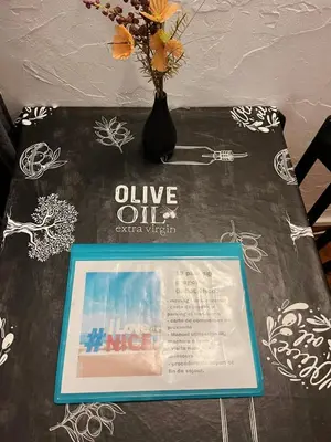 a table with a vase with a sign on it at appartement entresol nice 1,2 kilomètre de la plage mer promenade in Nice