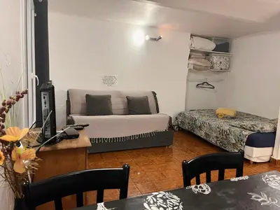 a small living room with a couch and a bed at appartement entresol nice 1,2 kilomètre de la plage mer promenade in Nice