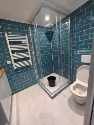a bathroom with a toilet and a glass shower at Charmant studio rénové – Place de la République in Villefranche-sur-Mer