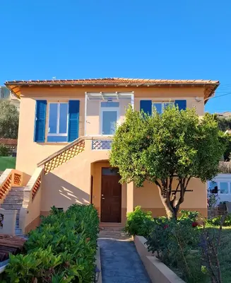 a house with a tree in front of it at Studio de la Villa Thérèse, Piscine & Jardin in Saint-Laurent-du-Var