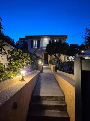 a pathway leading to a house at night at Studio de la Villa Thérèse, Piscine & Jardin in Saint-Laurent-du-Var
