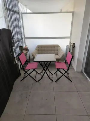 a table and two pink chairs in a room at riviera in Nice