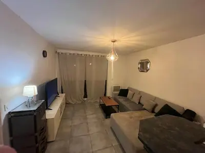 a living room with a couch and a table at Le Riviera in Nice