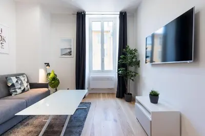 a living room with a couch and a tv at 1 CASSINI LOT 5 - Magnifique Studio - Garibaldi - Port in Nice