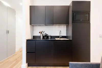 a black kitchen with a sink and a microwave at 1 CASSINI LOT 5 - Magnifique Studio - Garibaldi - Port in Nice