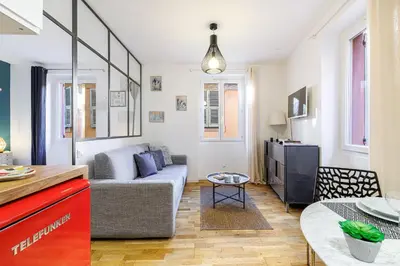 a living room with a couch and a table at 1 GALLO LOT 3 - Joli appartement au coeur du Vieux-Nice - AC in Nice