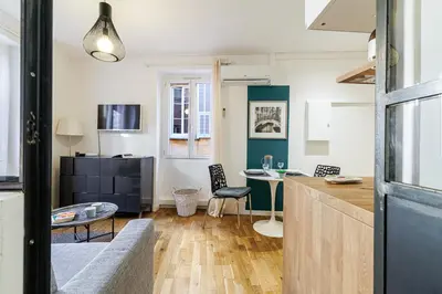 a kitchen and a living room with a table at 1 GALLO LOT 3 - Joli appartement au coeur du Vieux-Nice - AC in Nice