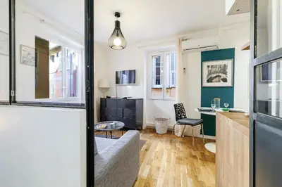 a living room with a couch and a table at 1 GALLO LOT 3 - Joli appartement au coeur du Vieux-Nice - AC in Nice
