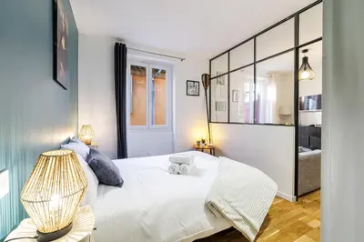 a bedroom with a white bed and a window at 1 GALLO LOT 3 - Joli appartement au coeur du Vieux-Nice - AC in Nice