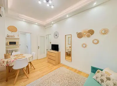 a living room with a table and a dining room at Cherie in Nice in Nice