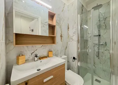 a bathroom with a sink and a glass shower at Cherie in Nice in Nice