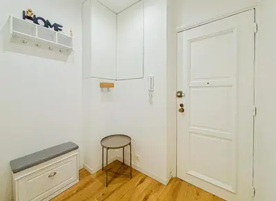 a white room with a stool and a door at Cherie in Nice in Nice