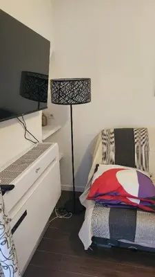 a bedroom with a desk and a bed and a lamp at Nice 2-room apartment off the beach in Nice