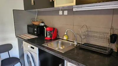 a kitchen counter with a sink and a microwave at Nice 2-room apartment off the beach in Nice