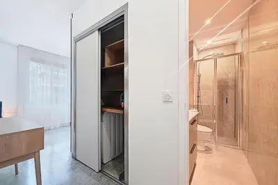 a bathroom with a walk in closet with a glass door at Beach Studio on Cagnes sea front in Cagnes-sur-Mer