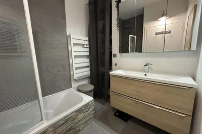 a bathroom with a tub and a sink and a shower at Spacious apartment in Nice with balcony in Nice