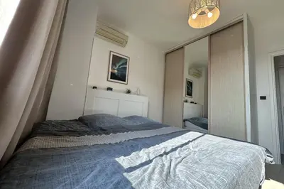 a bedroom with a bed with a blue blanket at Spacious apartment in Nice with balcony in Nice