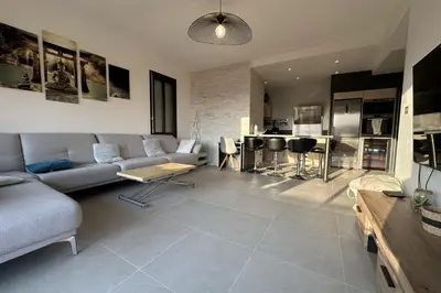 a large living room with a couch and a kitchen at Spacious apartment in Nice with balcony in Nice