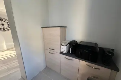 a kitchen with a cupboard with a coffee maker at Spacious apartment in Nice with balcony in Nice