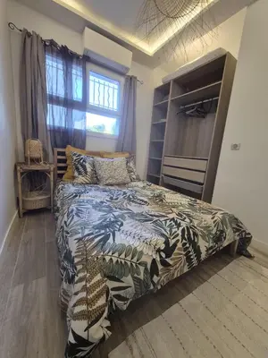 a bedroom with a bed and a large window at petit appart cozy in Nice