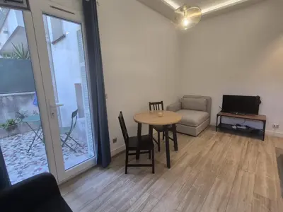 a living room with a table and a couch at petit appart cozy in Nice