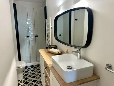 a bathroom with a white sink and a mirror at Chic et élégant - au cœur du Carré d'Or in Nice