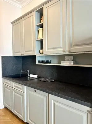 a kitchen with white cabinets and a sink at Chic et élégant - au cœur du Carré d'Or in Nice