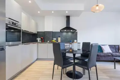 a kitchen and dining room with a table and chairs at Beautiful 2 bedrooms apartment close to the sea in Nice