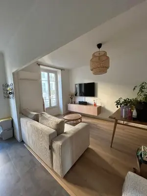 a living room with a couch and a table at Charming bright apartment in Nice in Nice