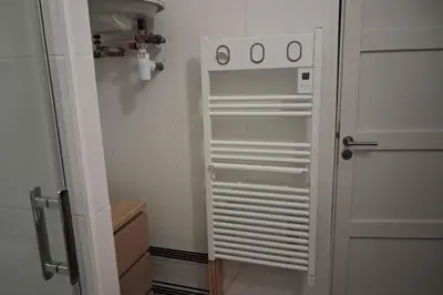 a small white refrigerator in a small room at Charming bright apartment in Nice in Nice