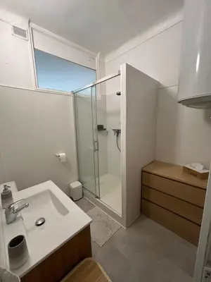 a bathroom with a glass shower and a sink at Charming bright apartment in Nice in Nice