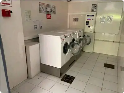 a kitchen with a washing machine in a room at Mer et Soleil in Villefranche-sur-Mer