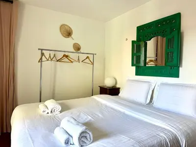 a bedroom with a white bed with towels on it at L'âme de Nice - Terrasse dorée sur Place Masséna in Nice