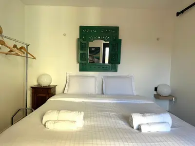 a large white bed with two pillows on it at L'âme de Nice - Terrasse dorée sur Place Masséna in Nice