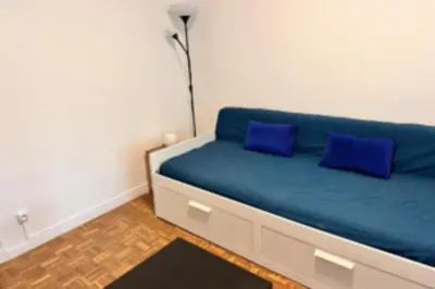 a blue couch with two blue pillows in a room at Studio with veranda 5min walk to the beach in Nice