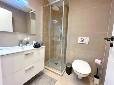 a bathroom with a toilet and a glass shower at Ref 127 - 3 Pièces 2 chambres Nice Port in Nice