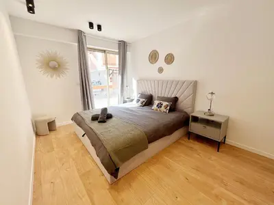 a bedroom with a bed and a large window at Ref 127 - 3 Pièces 2 chambres Nice Port in Nice