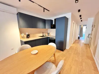 a kitchen and dining room with a wooden table and chairs at Ref 127 - 3 Pièces 2 chambres Nice Port in Nice