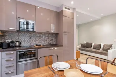 a kitchen and dining room with a table and a couch at Authentic Nice Old Town, separate bedroom, AC in Nice