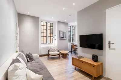 a living room with a couch and a flat screen tv at Authentic Nice Old Town, separate bedroom, AC in Nice