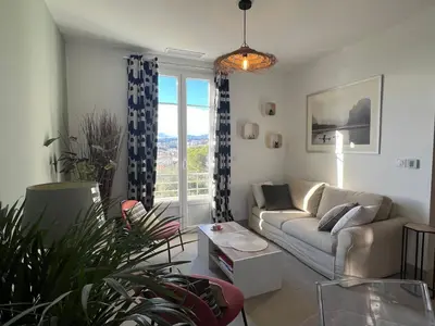 a living room with a couch and some plants at Golden hours luxury and panoramic view in Nice
