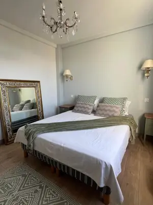 a bedroom with a large bed and a mirror at Golden hours luxury and panoramic view in Nice