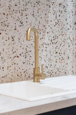 a sink with a gold faucet in a bathroom at Cocon stylé Centre et mer à pied CLIM WIFI in Nice