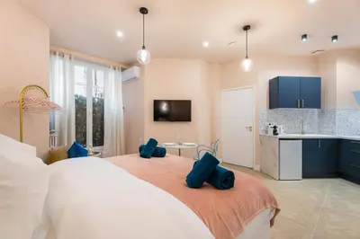 a bedroom with a large bed with blue pillows on it at Cocon stylé Centre et mer à pied CLIM WIFI in Nice